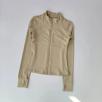 Jlynx beige zip up women's high neck workout jacket flat lay with thumbholes and contoured seams